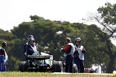 Jenson Button stopped on track